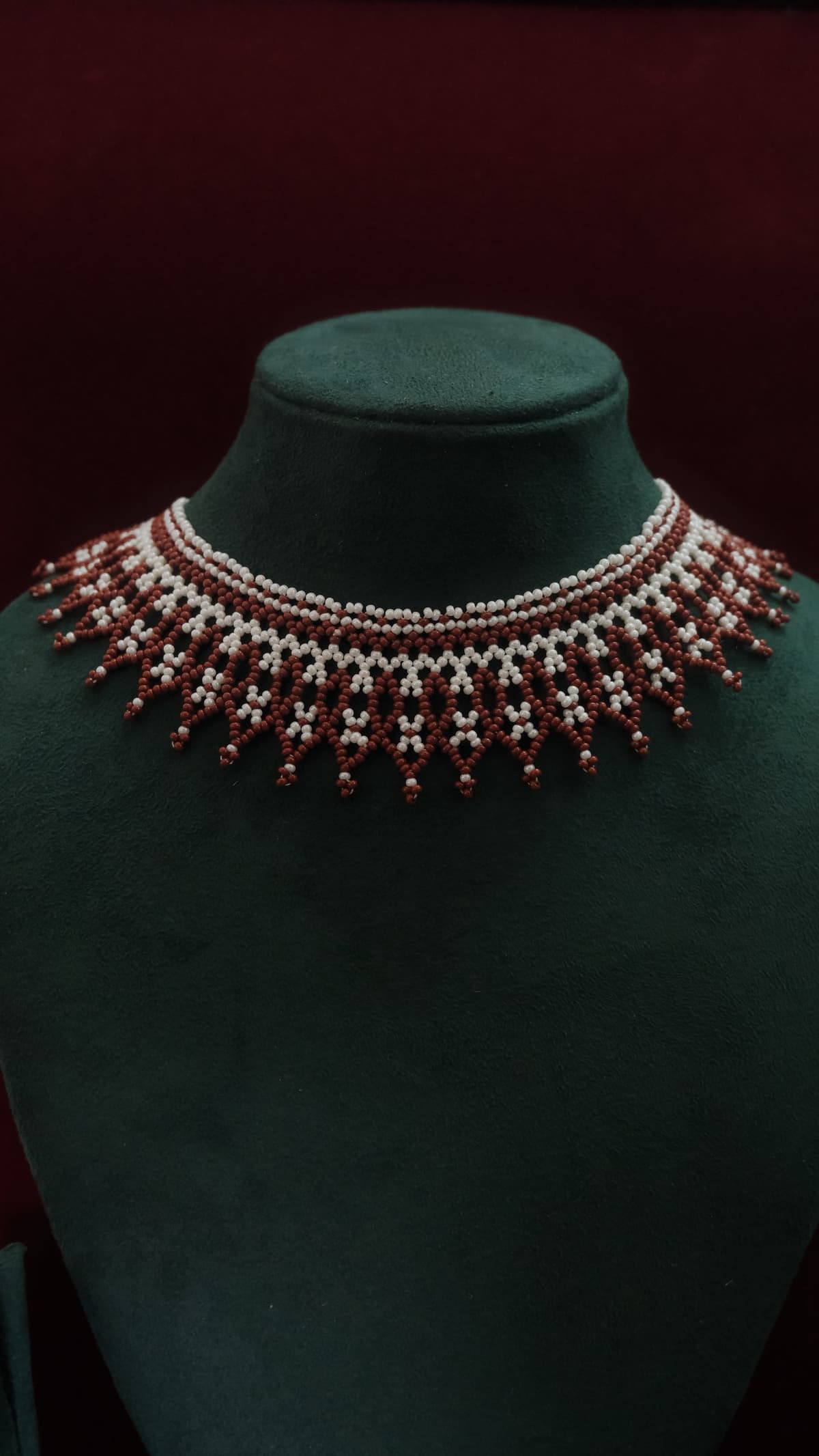 A wide handwoven bridal collar in red, white and gold